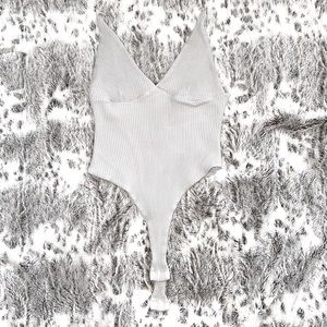 Sleeveless white vneck ribbed bodysuit